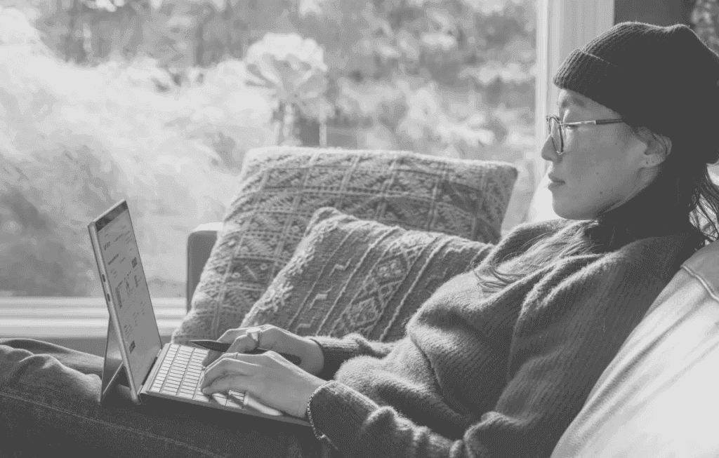 A person sleeping on a couch with an open book.