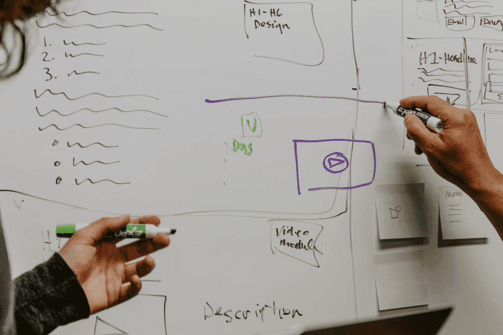 Person writing on a large sheet of paper.