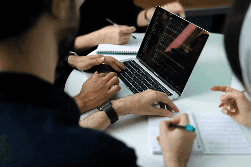 People using notebook devices in a meeting place.
