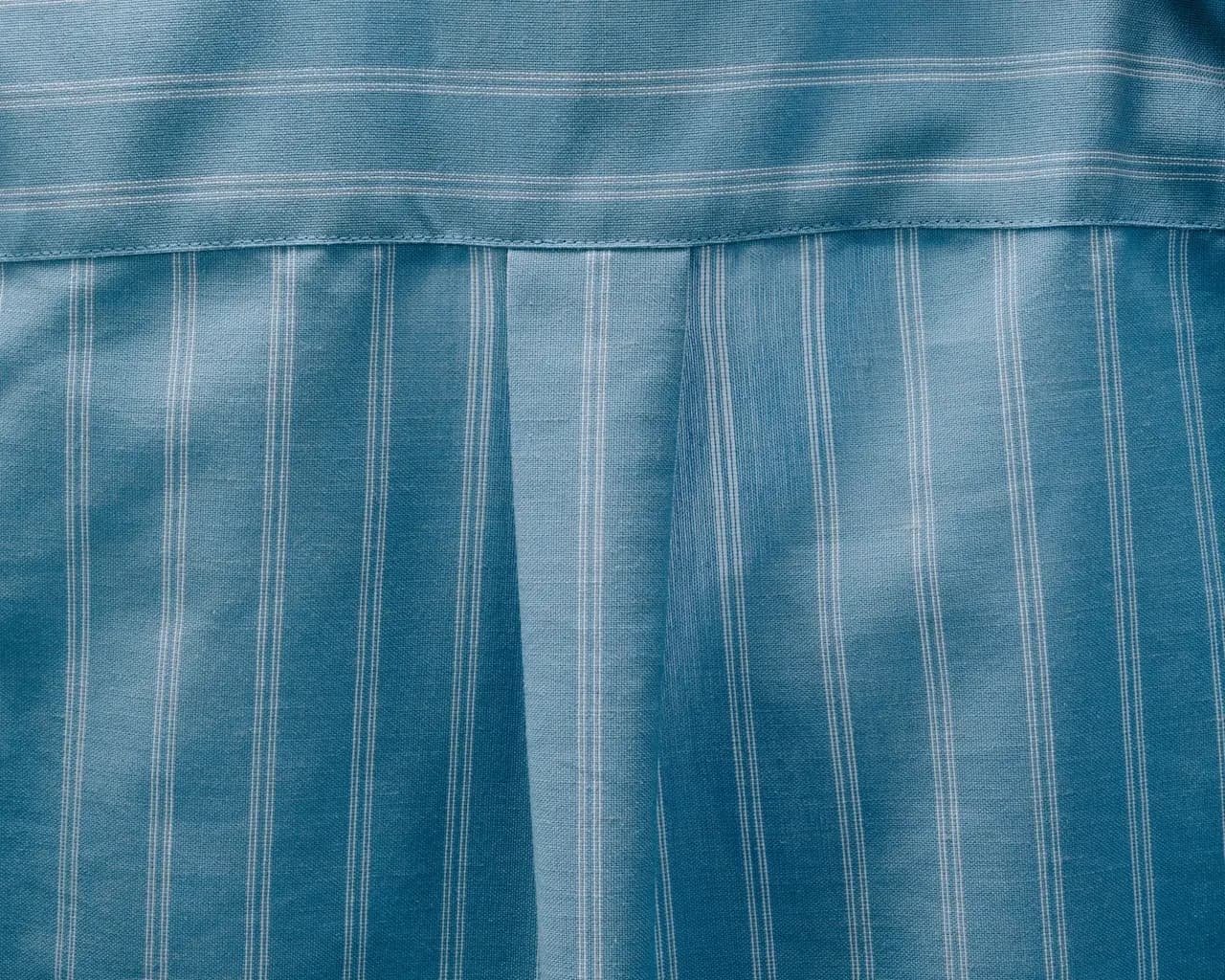 A close-up, artistic shot of pinstriped blue fabric